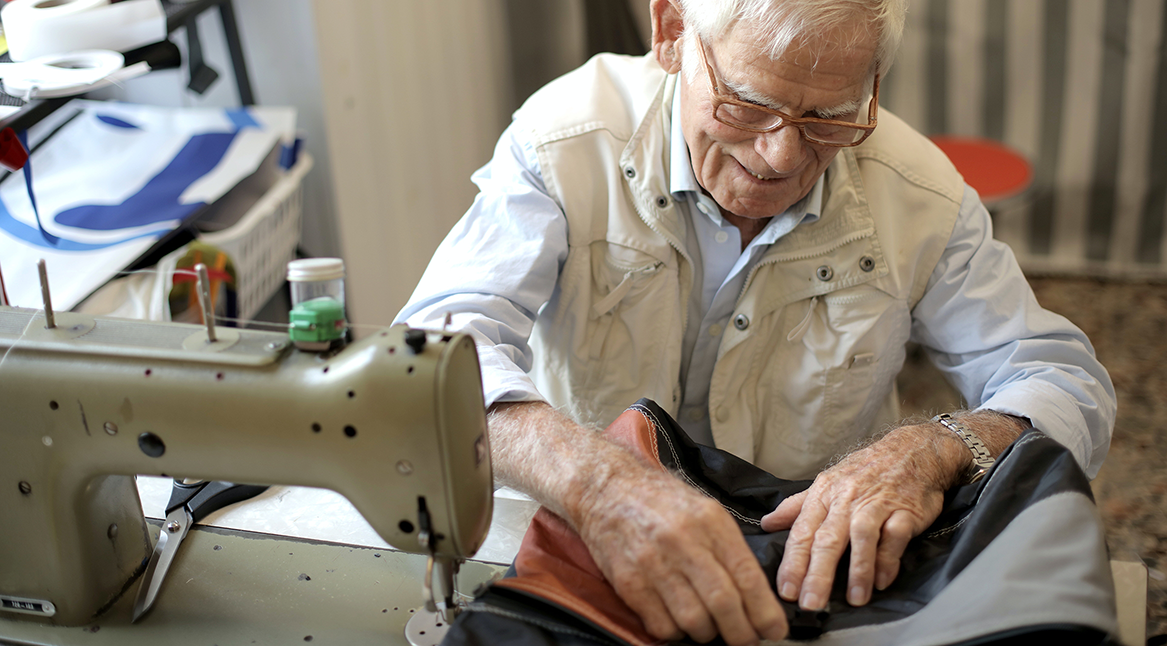 Grandad using sewing machine